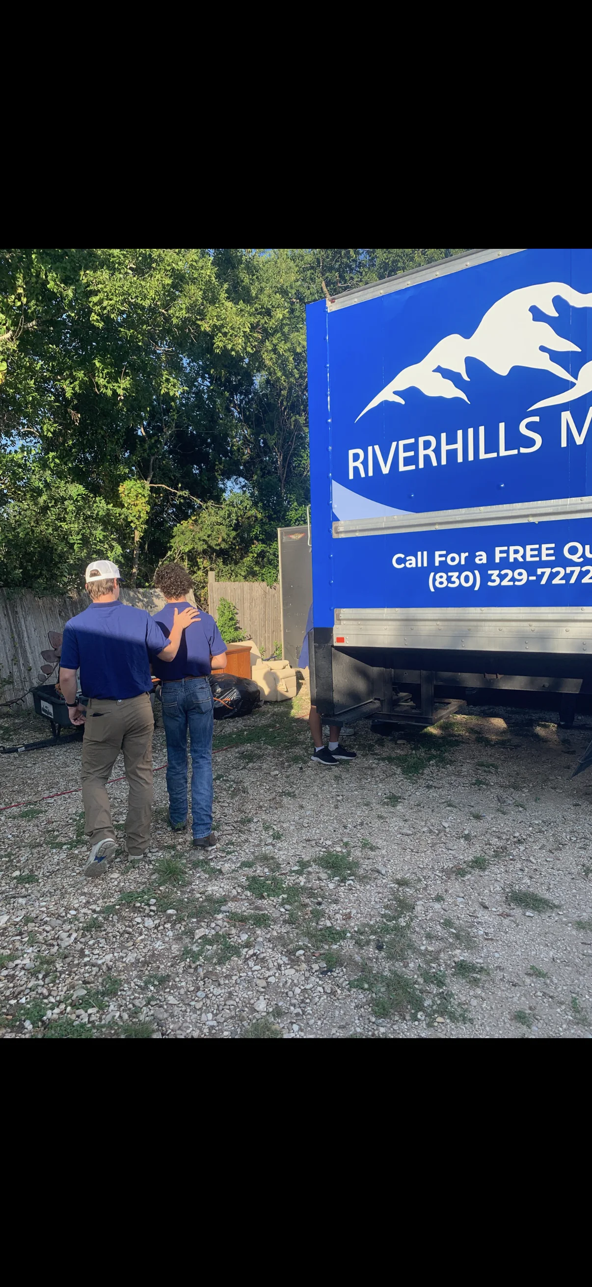 RiverHills Moving crew beside the company box truck